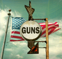 aged and worn vintage photo of guns sign with American flag
