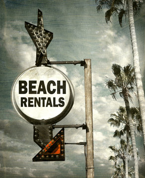 Aged And Worn Vintage Photo Of Beach Rentals Sign With Palm Trees