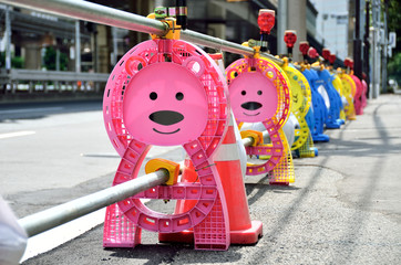 Bear-shaped post of barricade at construction site, Japan