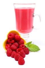 Fresh raspberries pouring out of yellow bowl and fresh cocktail