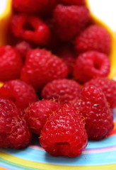Fresh raspberries on colorful plate