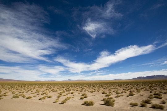 Mountains and arid landscape with blue sky in Bolivia