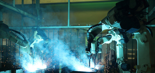 group welding robots are working In the automotive parts industry.