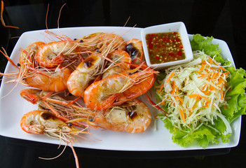Fried frog legs with olive, herbs and spices
