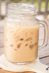 Iced milk coffee on wooden table