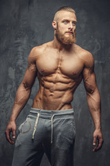 Obraz na płótnie Canvas Shirtless bodybuilder with beard.