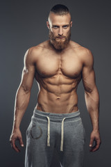 Fototapeta premium Portrait of muscular shirtless man with beard.