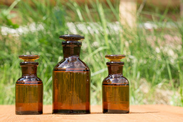 little brown bottles on booden board and grass