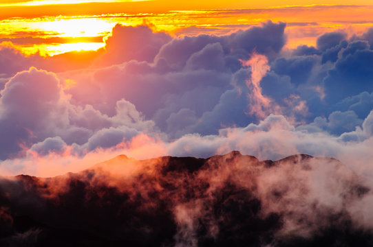 Clouds at sunrise over Haleakala Crater, Maui, Hawaii, USA