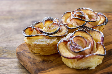 apple shaped rose dessert on wooden table