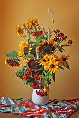 Still life with a bouquet of  yellow and red flowers on a bright