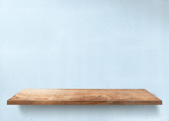 Wooden table with light blue wall