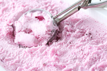 Sweet ice cream scooped out from container