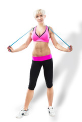 Sportive woman with the tape measure, studio shot, gray background