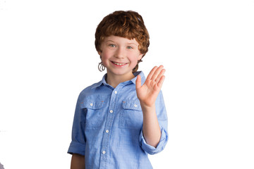 Handsome smiling boy waving with his hand. Isolated on white