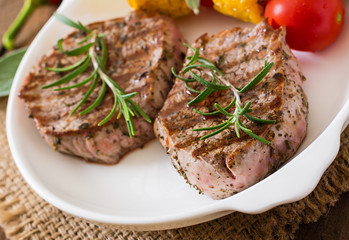 Tender and juicy veal steak medium rare with vegetables