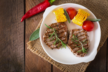Tender and juicy veal steak medium rare with vegetables