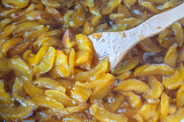 shot of cooking and preparing homemade apricot or peach jam in a