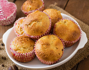 Fruit muffins with nutmeg and allspice on a wooden background