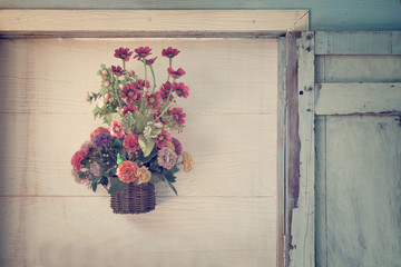 Artificial flowers on wood wall