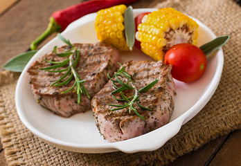 Tender and juicy veal steak medium rare with vegetables