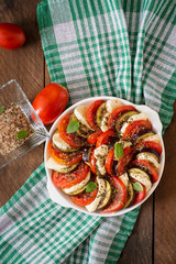 Prepared gratin dish raw eggplant with mozzarella and tomatoes