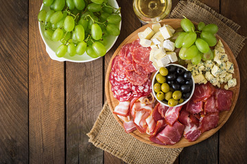 Antipasto catering platter with bacon, jerky, salami, cheese and grapes 
