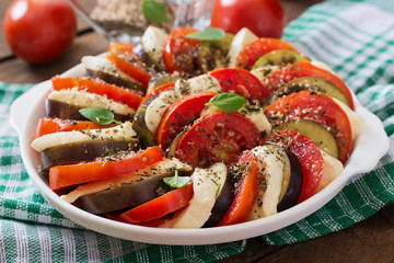 Prepared gratin dish raw eggplant with mozzarella and tomatoes