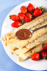 Pancakes with chocolate and strawberries