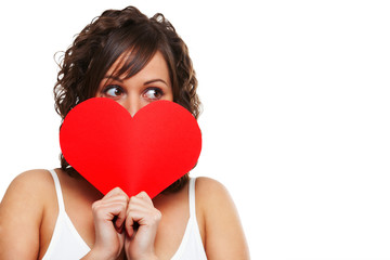 Young woman holding red paper heart