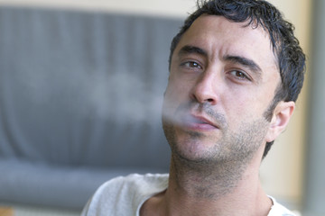 Fototapeta premium Attractive man smoking a cigarette