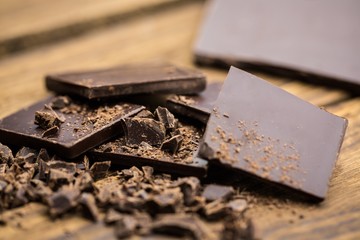 Pieces of chocolate on a wooden table