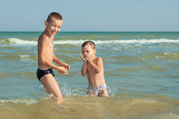 Happy  Children - two boys having fun on the beach
