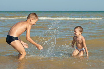 Happy  Children - two boys having fun on the beach