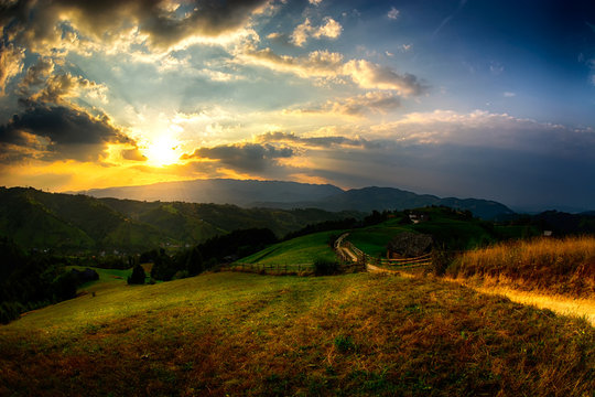 Evening, sunset on mountain hills of Simon village. Bran.