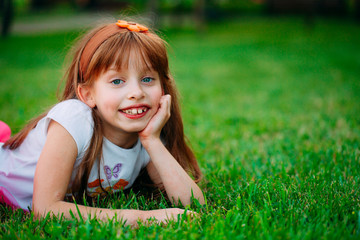 Little girl lying on the grass