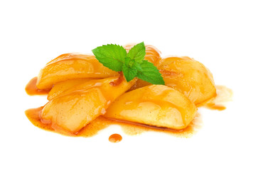 Caramelized pear in cognac sauce with leaf mint. Isolated on