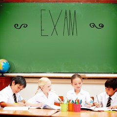 Exam against cute pupils sitting at desk