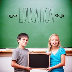 Education against cute pupils showing chalkboard