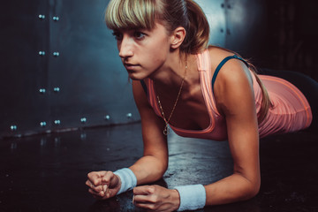 Obraz na płótnie Canvas Slim fitness young woman Athlete girl doing plank exercise