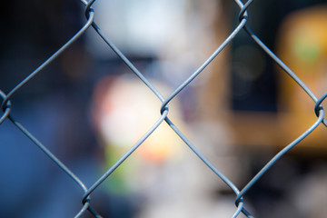 Cyclone fence in front of blurred out cityscpae