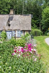 Fototapeta na wymiar charming home / charming half-timbered house with a beautiful flower garden