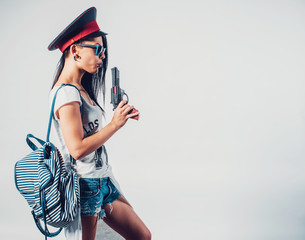 Fashion swag sexy girl blowing on smoke toy gun woman having fun