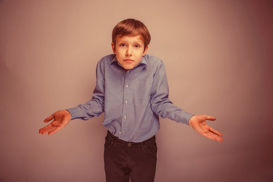 boy teenager of European appearance brown hair threw up his hand