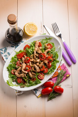 chicken salad with arugula ,tomatoes and balsamic vinegar