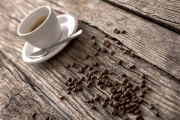 Coffee beans and coffee on a rustic table