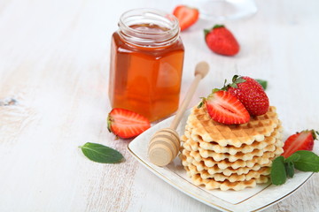 Waffles, mint and ripe strawberries.