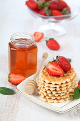 Waffles, mint and ripe strawberries.