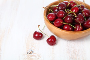Ripe cherry in a wooden bowl