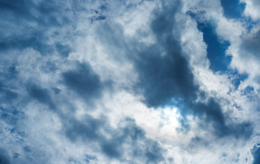 Dark sky before rain and sun behind cloud